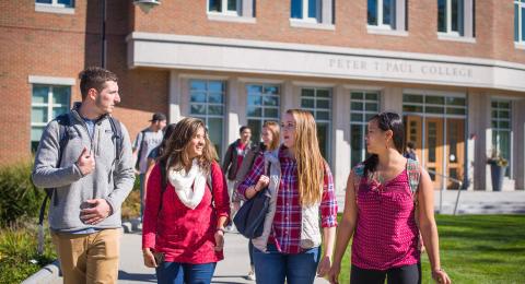 Students walking in front of the Peter T. Paul Building