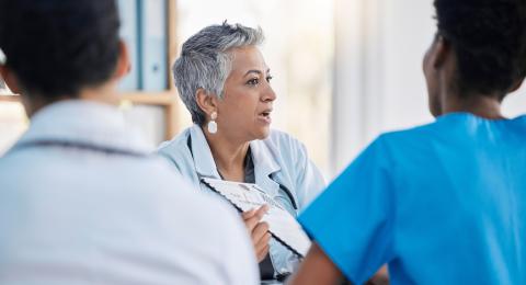 female healthcare executive speaking with her staff