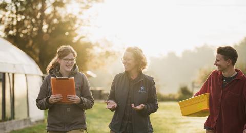 UNH students walk with an agriculture professor to look at UNH's local gardens and farms.