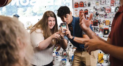 UNH students involved in Paul College's student-run marketing agency, Voice Z Digital, shoot content on site with a client.