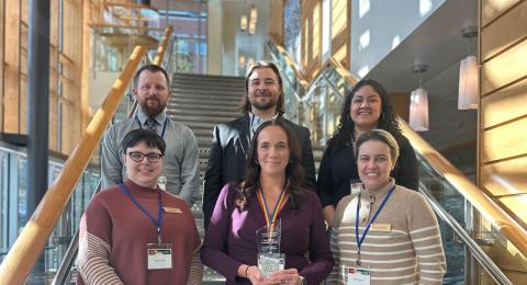 Graduate Programs staff on staircase of business school.