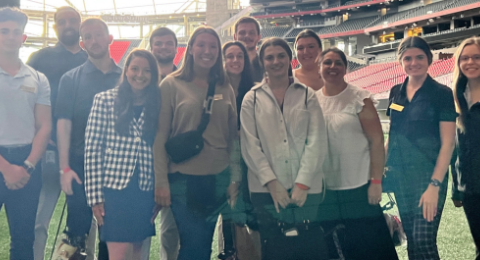 Dean's Ambassadors pose on the field at the Mercedes Benz Stadium in Atlanta, GA