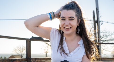 Jacqui Driscoll slides a hand through her hair while laughing at the camera