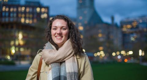 Jill Howard stands in Boston cityscape at night