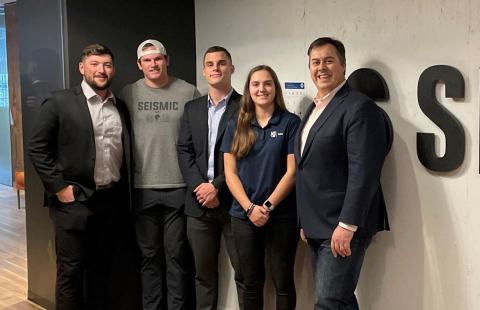Professional Sales Group students pose in front of company sign