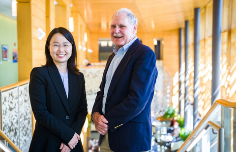 UNH Paul College Jeff Sohl and Joanhong Chen standing at top of Great Hall stiars
