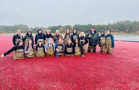 UNH students pose for photo in cranberry bog