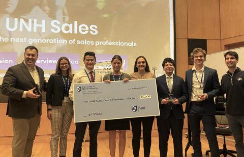 UNH Sales Role Play Competition winners with big check