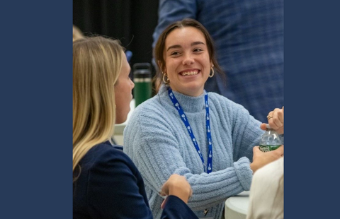 Two female students chatting at UNH Women in Sales Event 