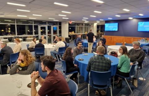 Groups of people talking at round tables