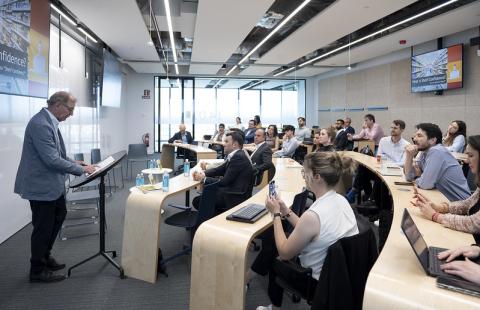 Thomas Gruen reads from his book to a crowd at the IE Business School in Madrid, Spain.