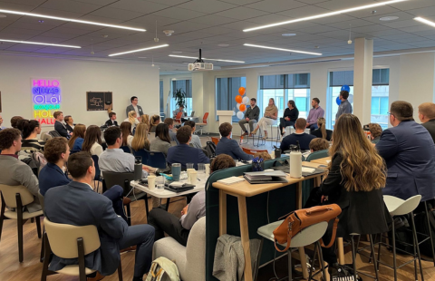 A full room of students facing a panel of professionals