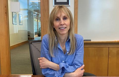 Sherri Cannon sits at a conference room table at Paul College
