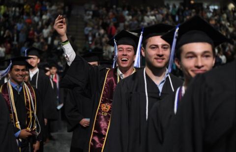 Students celebrate at the Peter. T Paul College of Business and Economics commencement ceremony.