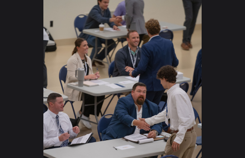 Students going from table to table at Speed Sell 2024