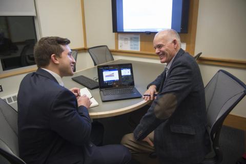two men talking at a table