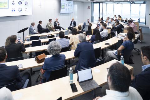 A panel speaks to a full classroom at IE Business School in Madrid, Spain.