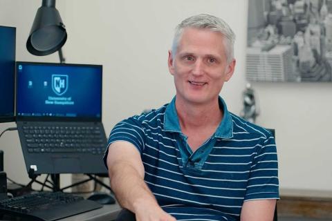 Russell Miles sits at his desk at UNH. Russell Miles sits at his desk at UNH.