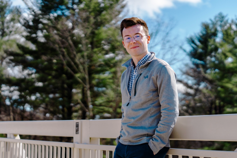 Parker Armstrong '20 A male student leans against a railing with his hands in his pockets.