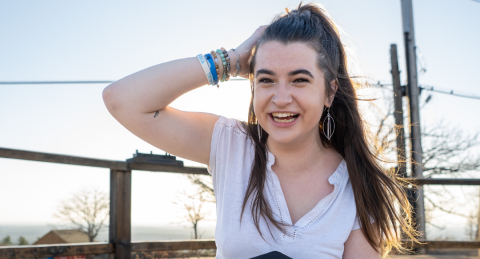 Jacqui Driscoll slides a hand through her hair while laughing at the camera