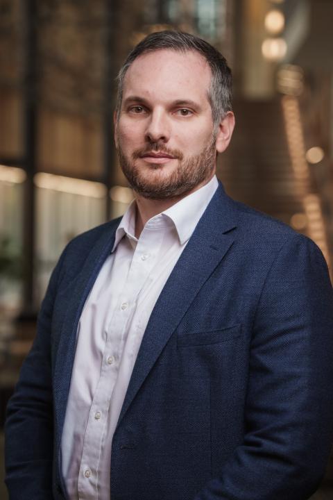 Headshot of Gonzalo Basante Perreira, man with a button up shirt and suit jacket, short hair and facial hair,